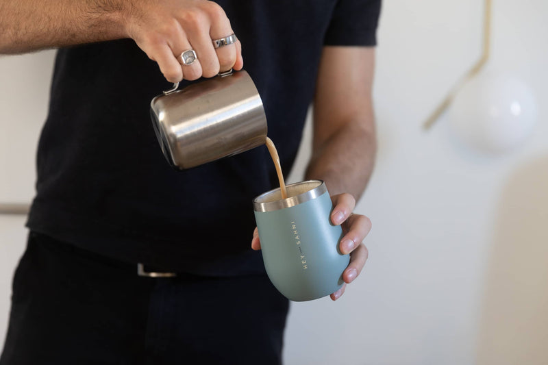 HEY SAHNI reusable stainless steel coffee cup on a desk in an office setting